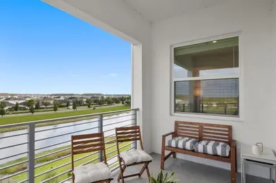 two benches sitting on a balcony with a view at Modern Storey Lake Resort Disney Orlando 3161-401 in Kissimmee