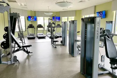 a gym with several treadmills and machines at Modern Storey Lake Resort Disney Orlando 3161-401 in Kissimmee