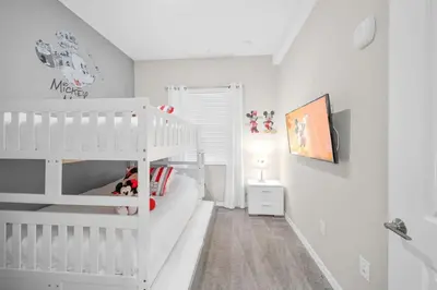 a white childs bedroom with a white bunk bed at Modern Storey Lake Resort Disney Orlando 3121-402 in Kissimmee