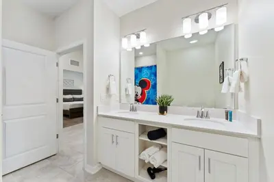 a white bathroom with a sink and a mirror at Modern Storey Lake Resort Disney Orlando 3161-405 in Kissimmee