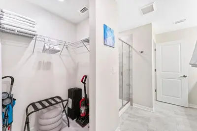 a room with a walk in closet with a glass door at Brand New Lakeview Storey Lake Resort Disney 3121-103 in Kissimmee