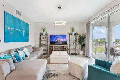 a living room with a couch and a tv at Modern Storey Lake Resort Disney Orlando 3171-302 in Kissimmee