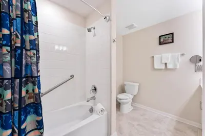 a white bathroom with a tub and a toilet at Modern Storey Lake Resort Disney Orlando 3171-302 in Kissimmee