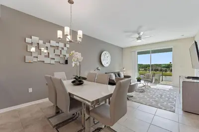 a dining room with a white table and chairs at Modern Storey Lake Resort Disney Orlando 3171-304 in Kissimmee