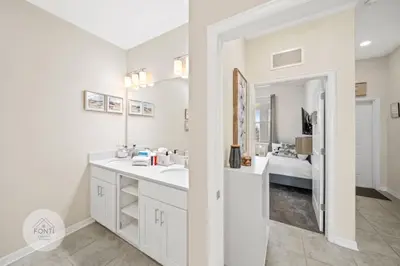 a white bathroom with a sink and a mirror at Modern Storey Lake Resort Disney Orlando 3161-402 in Kissimmee