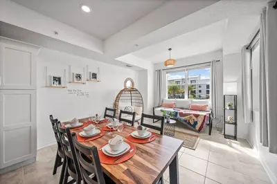 a dining room with a wooden table and chairs at Modern Boho Storey Lake Resort Disney 3180-207 in Kissimmee