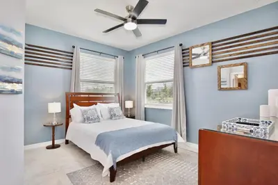 a bedroom with a bed and a ceiling fan at Modern Storey Lake Resort Disney Orlando 3121-108 in Kissimmee