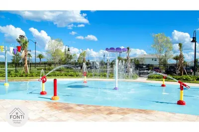 a pool with a water fountain in a park at Modern Storey Lake Resort Disney Orlando 3171-301 in Kissimmee