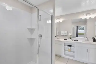 a white bathroom with a shower and a sink at Modern Storey Lake Resort Disney Orlando 4741-104 in Kissimmee