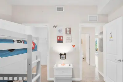 a bedroom with two bunk beds and a desk at Modern Storey Lake Resort Disney Orlando 3141-105 in Kissimmee