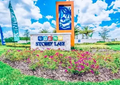 a sign in a flower bed with flowers at Modern Storey Lake Resort Disney Orlando 3141-105 in Kissimmee