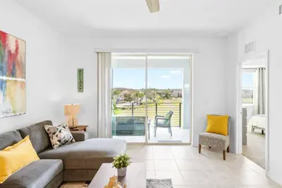 a living room with a couch and a table at Modern Storey Lake Resort Disney Orlando 3191-204 in Kissimmee