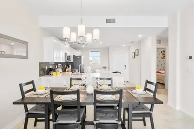 a kitchen and dining room with a table and chairs at Modern Storey Lake Resort Disney Orlando 3161-305 in Kissimmee