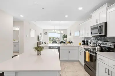 a kitchen with white cabinets and a white counter top at Modern Storey Lake Resort Disney Orlando 3161-305 in Kissimmee
