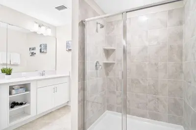a bathroom with a shower with a glass door at Modern Storey Lake Resort Disney Orlando 3161-305 in Kissimmee