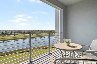 a balcony with a table and chairs and a view at Modern Storey Lake Resort Disney Orlando 3161-305 in Kissimmee