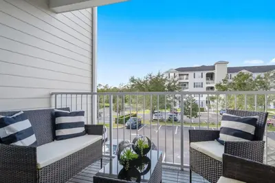 a balcony with two chairs and a view of a street at Secret Lake Resort 3BR Apt Disney Orlando 3175-205 in Kissimmee