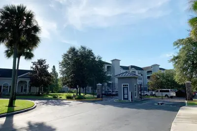 a street in a residential neighborhood with a palm tree at Secret Lake Resort 3BR Apt Disney Orlando 3175-205 in Kissimmee