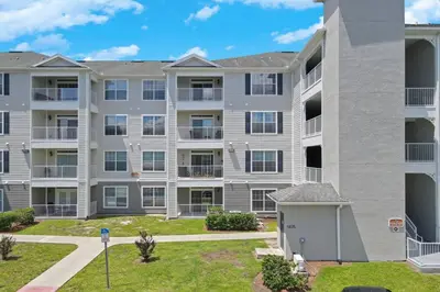 an apartment building with balconies and a yard at Secret Lake Resort 3BR Apt Disney Orlando 3175-205 in Kissimmee