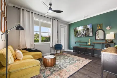 a living room with a couch and a table at 5 Bdr 4,5 Bth Villa - Pool Table - Fenced Yard in Orlando