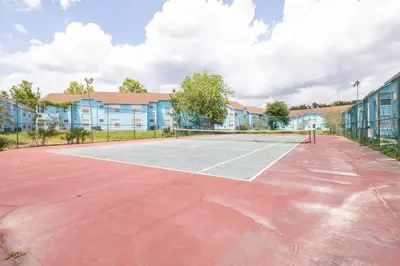 a tennis court in front of a building at The Villa of Somerset in Kissimmee
