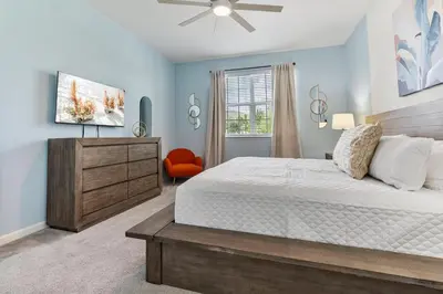 a bedroom with a bed and a ceiling fan at Beautiful 12Bed11.5Bath House At Bella Vida in Kissimmee