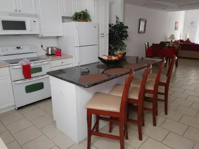 a kitchen with a counter and a table with chairs at Smart home near Disney world, Silver Spurs Arena in Kissimmee