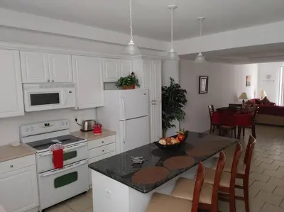 a kitchen with a table with a bowl of fruit on it at Smart home near Disney world, Silver Spurs Arena in Kissimmee