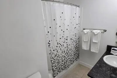 a bathroom with a shower curtain and a sink at Smart home near Disney world, Silver Spurs Arena in Kissimmee