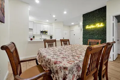 a dining room and kitchen with a table and chairs at Windsor Hills Spacious Condo,Pool,Slides,By Disney in Orlando