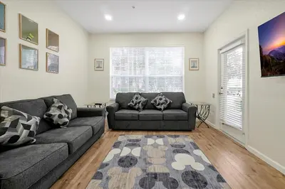 a living room with two couches and a rug at Windsor Hills Spacious Condo,Pool,Slides,By Disney in Orlando