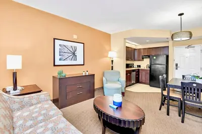a living room with a couch and a table at Modern 1BR-King Bed with Pool & Hot Tub-Near Disney in Orlando