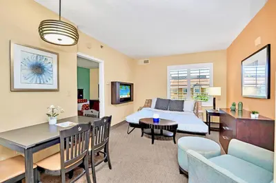 a living room with a couch and a table at Modern 1BR-King Bed with Pool & Hot Tub-Near Disney in Orlando