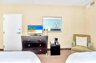a hotel room with a bed and a chair at Apartment with Pool & Hot Tub - Close to Universal Studios in Orlando