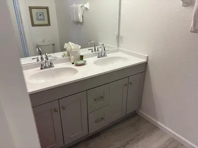a bathroom with two sinks and a mirror at Casa Mickey in Orlando