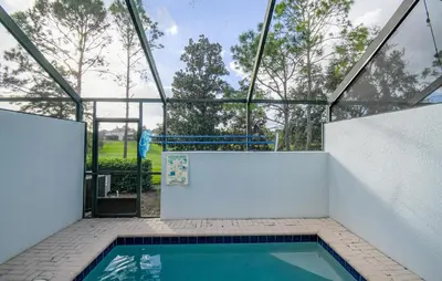 a swimming pool inside of a glass house at Casa Mickey in Orlando