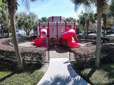 a playground with a red slide in a park at Casa Mickey in Orlando