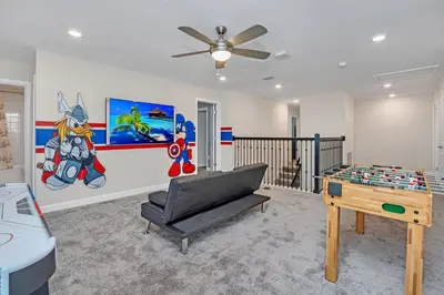 a living room with a ping pong table and a couch at AVH-2746-SL in Kissimmee