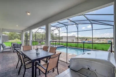 a large patio with a table and a bath tub at AVH-2746-SL in Kissimmee