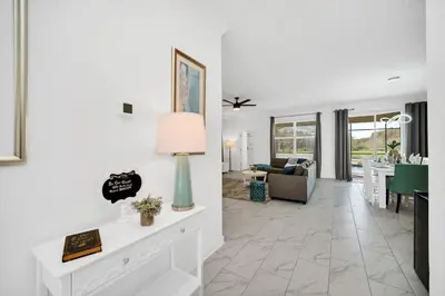 a living room with a couch and a table at Brand New 6BD, Gameroom / Movie Theater And Pool in Kissimmee