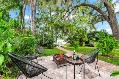 a patio with chairs and a fire pit at Spring Lake King Balcony Suite in Orlando