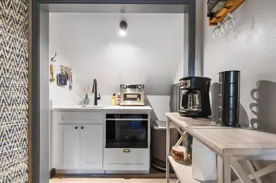 a small kitchen with a counter and a microwave at Spring Lake King Balcony Suite in Orlando