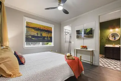 a bedroom with a bed and a ceiling fan at 2 King En Suite Fenced Yard Pet Friendly in Orlando