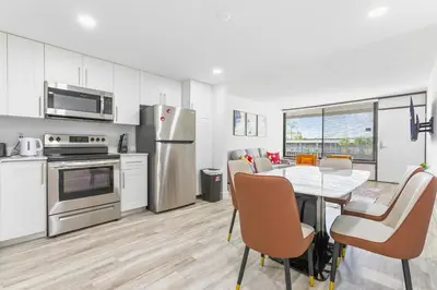 a kitchen and dining room with a table and chairs at 15 Mins from Disney World l Theme Room l Pool in Kissimmee
