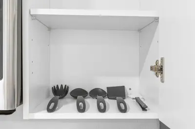 a shelf with scissors and other kitchen utensils on it at 15 Mins from Disney World l Theme Room l Pool in Kissimmee