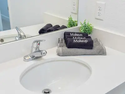 a bathroom sink with a mirror and a white sink at 15 Mins from Disney World l Theme Room l Pool in Kissimmee