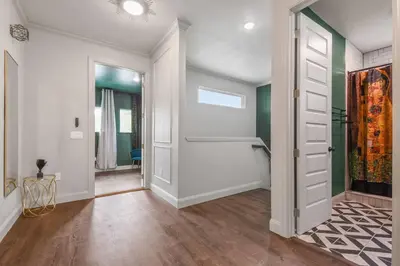 an empty hallway with a white door and green walls at Pool Table, BBQ, Walking Distance to Local Gems in Orlando