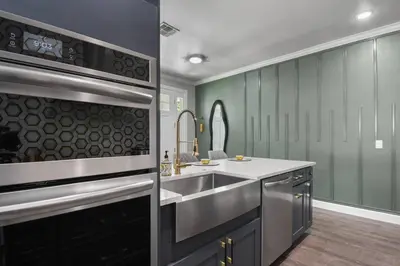 a kitchen with a sink and a stove at Pool Table, BBQ, Walking Distance to Local Gems in Orlando