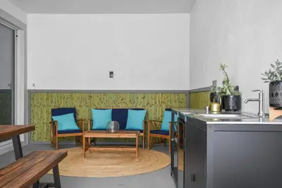 a kitchen with blue chairs and a table and a sink at Pool Table, BBQ, Walking Distance to Local Gems in Orlando