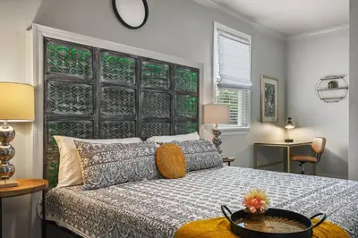 a bedroom with a bed with a large headboard at Pool Table, BBQ, Walking Distance to Local Gems in Orlando